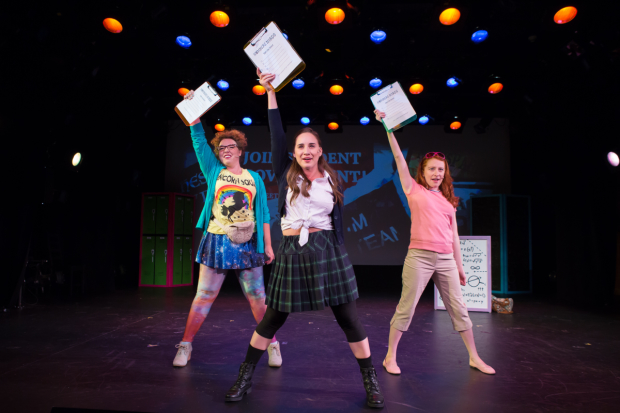 Mathletes Barbie (Madison Kauffman, left), Mary Kate (Danielle Davila, center), and Amber (Tiffany Tatreau) brandish their clipboards in Numbers Nerds, directed by Amber Mak, at Playwrights Horizons.  