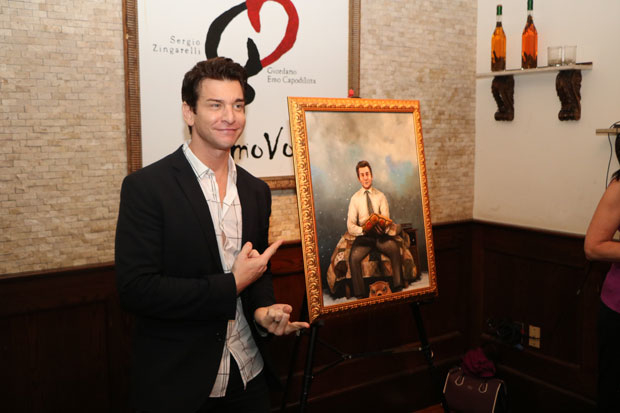 Andy Karl poses next to the painting of him unveiled at Tony di Napoli Restaurant.