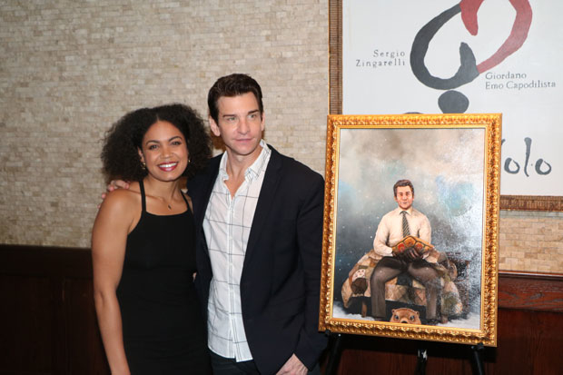 Costars Barret Doss and Andy Karl pose for a photo with the painting.