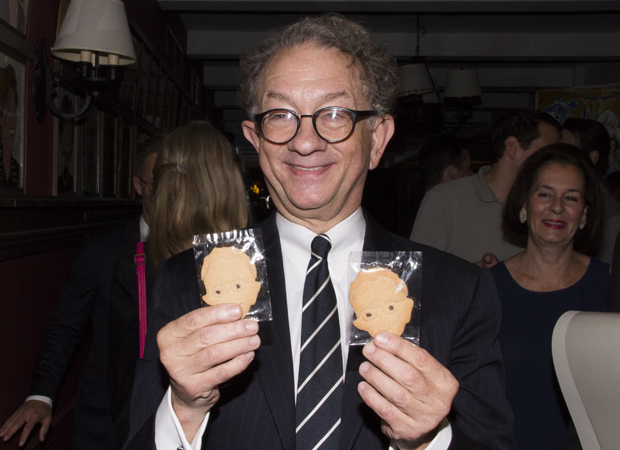 An amused William Ivey Long holds cookies made in his likeness.