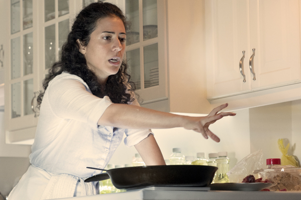 Nadine Malouf reaches for a plate of meat in Oh My Sweet Land.
