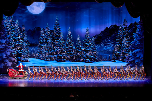 Santa Claus and his reindeer take the stage at Radio City Music Hall.