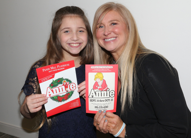 Peyton Ella and Tara Kennedy show off brochures from their respective productions of Annie at Paper Mill Playhouse.