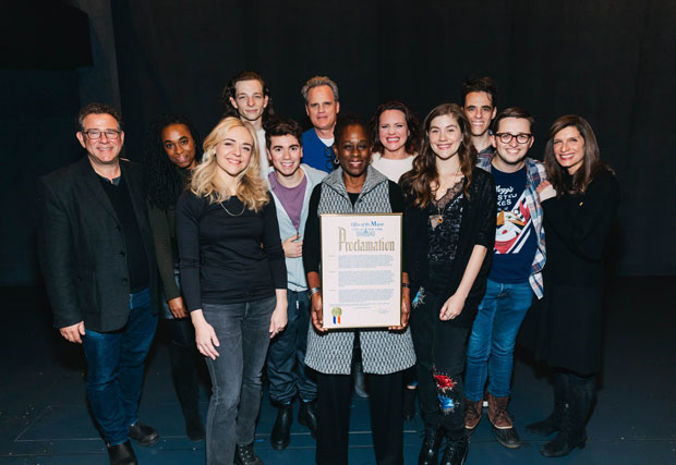 The company of Dear Evan Hansen grab a photo with their proclamation from the Mayor&#39;s Office.