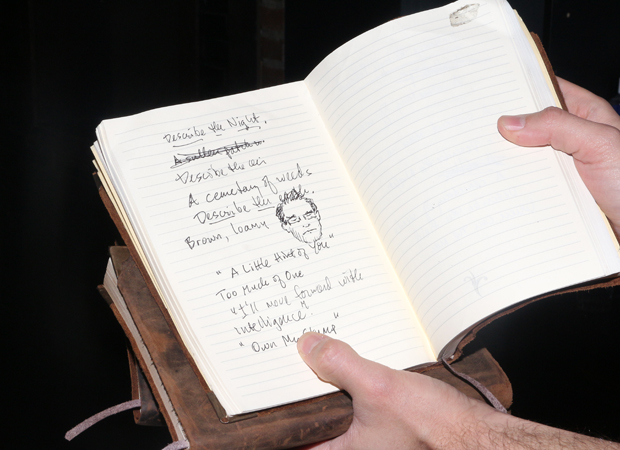 An onstage notebook is written in by actor Danny Burstein.