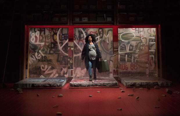 Rebecca Naomi Jones during the fall of the Berlin Wall, with the rocks scattered around the stage.