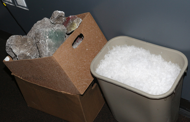 A box of rocks and a garbage pail of snow await their stage time.