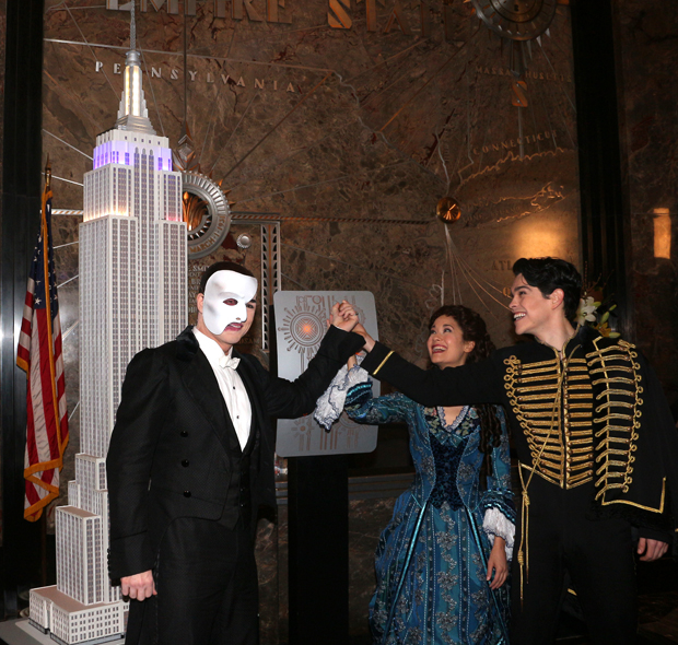 In costume, Peter Jöback, Ali Ewoldt, and Rodney Ingram flip the switch to light the Empire State Building in honor of The Phantom of the Opera.