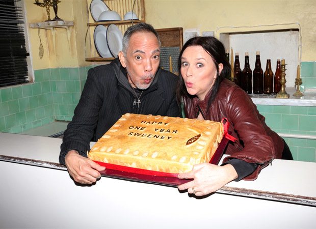Thom Sesma and Sally Ann Triplett pose with Sweeney Todd&#39;s one-year anniversary cake.