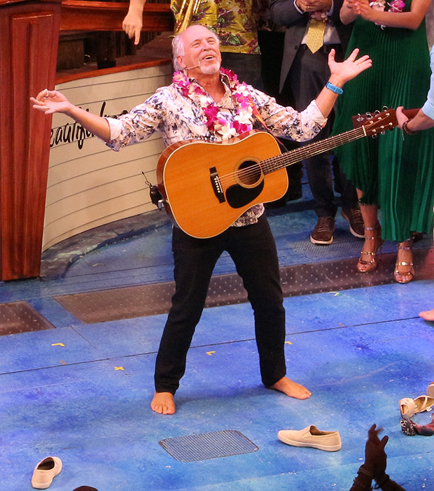 With his shoes off, Jimmy Buffett parties on stage during the opening night of Escape to Margaritaville on Broadway.