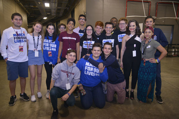 Producer Yael Silver takes a photo with Marjory Stoneman Douglas High School students at the From Broadway With Love benefit concert.