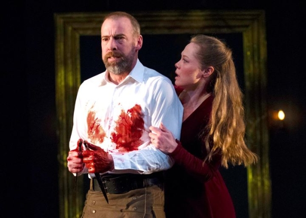 Ian Merrill Peakes and Chaon Cross as Macbeth and Lady Macbeth in a scene from Macbeth, adapted and codirected by Aaron Posner and Teller, at Chicago Shakespeare Theater.