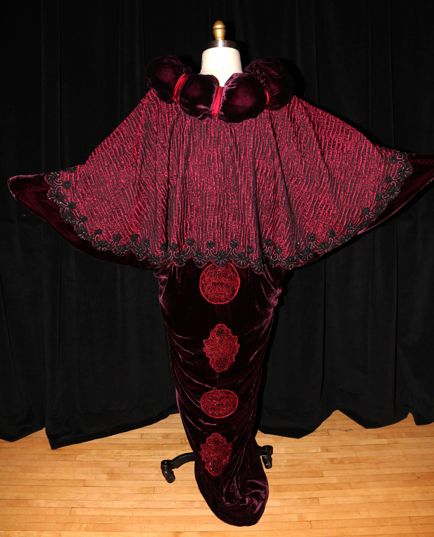 Ensemble costume from the opening scene of My Fair Lady. "This
particular costume was based on research from Paul Poiret," Zuber notes. Poiret's
influence can be seen in the triangular shape of the cape.