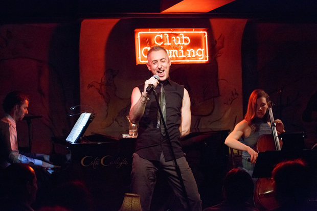 In 2015, Alan Cumming (center) debuted his show, Alan Cumming Sings Sappy Songs, at the Café Carlyle, in front of his neon Club Cumming sign and supported by pianist Lance Horne and cellist Eleanor Norton.