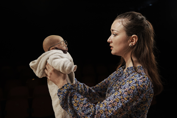 Amy Molloy as Julie, holding her daughter Mary-May as she dons Gerry Adams&#39;s beard and glasses. 
