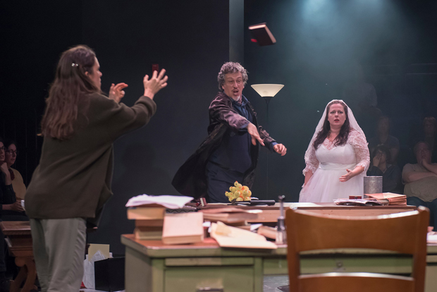 Susannah Millonzi (left) and Zuzanna Szadkowski (right) look on as Randolph Curtis Rand (center) throws the book at Chekhov and Shakespeare in Bedlam&#39;s Uncle Romeo Vanya Juliet.