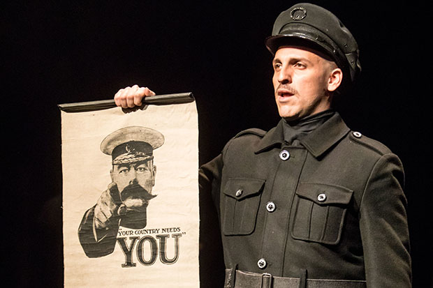 Rodolfo Nieto holds up a British recruitment poster in All Is Calm: The Christmas Truce of 1914.