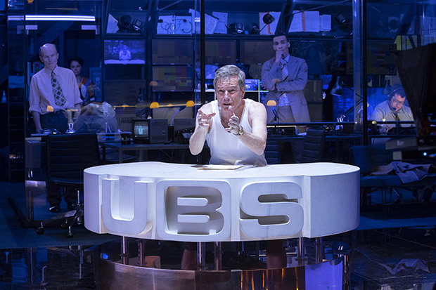 Howard Beale (Bryan Cranston) evangelizes to the airwaves, while the control booth looks on in Network.