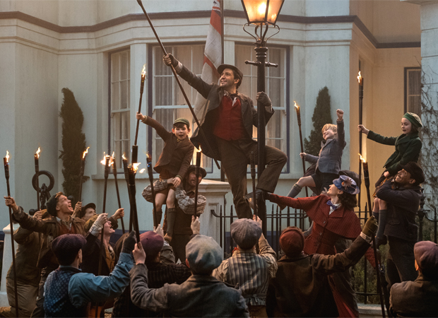 Lin-Manuel Miranda as Jack, with a chorus of lamplighters, in Mary Poppins Returns.