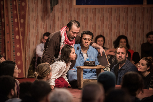 Vera Gurpinar (little girl), Ben Turner, and Mohammad Amiri in a scene from The Jungle, directed by Stephen Daldry and Justin Martin, at St. Ann&#39;s Warehouse.