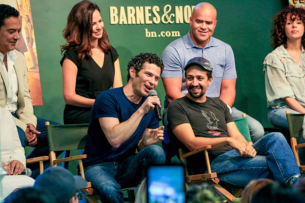 Thomas Kail and Lin-Manuel Miranda speak at another bookstore in 2018, surrounded by original cast members of In the Heights.