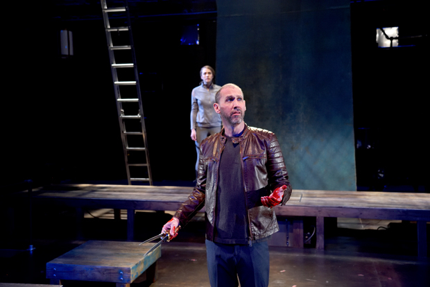 Mauro Hantman as Macbeth with Julia Atwood in the background as Lady Macbeth in Trinity Rep&#39;s new production of Macbeth.
