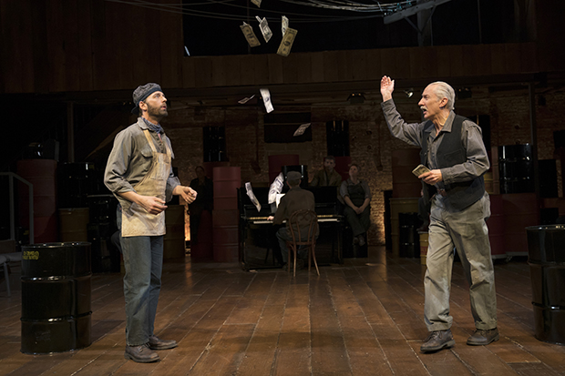 Mr. Mister (David Garrison, right) tosses money at Editor Daily (Ken Barnett) in The Cradle Will Rock.