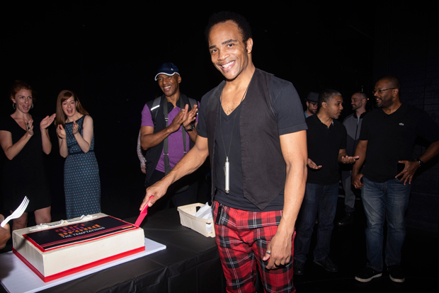 James Harkness takes the first cut into the cake to celebrate Ain&#39;t Too Proud&#39;s 100th Broadway performance.