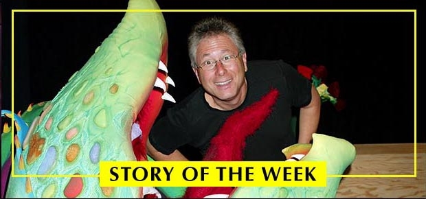 Composer Alan Menken climbs out of the Audrey II puppet from the 2003 Broadway production of Little Shop of Horrors.
