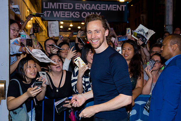 Tom Hiddleston gets ready to sign some autographs after Betrayal.