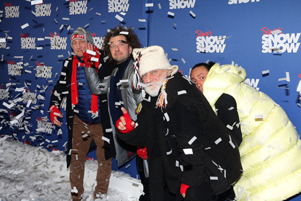 The company of Slava&#39;s Snow Show poses for photos in the snow.