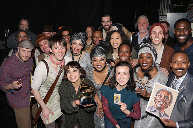 Hadestown cast and band members with a Grammy statue.