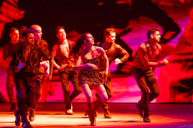 Yesenia Ayala as Anita and the cast of West Side Story on stage.