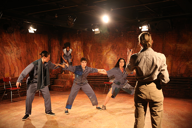 Tyree (Hope Ward) attempts to break through a wall formed by Abram (Fleece), Francisco (Melissa Navia), and Gregos (Lucille Duncan), and seize two plums from Otto (Laura Jordan).