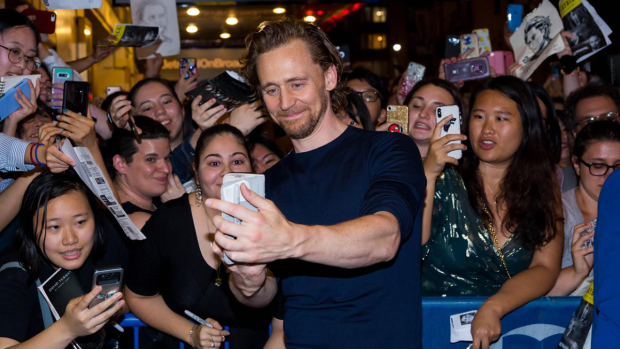 Tom Hiddleston takes a photo at the Betrayal stage door, something that would not be allowed once theater returns. 
