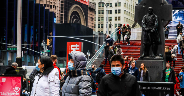 A trio of mask-wearers and hoards of nose-breathers in Times Square last spring.