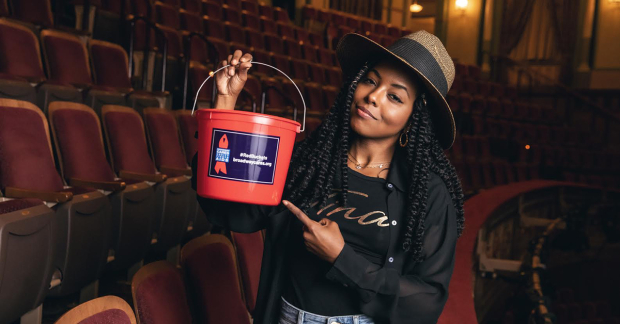 Adrienne Warren and the Broadway Cares red bucket