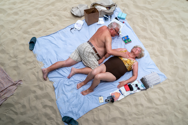 A couple of performers appear on a beach blanket in Sun &amp; Sea at BAM.