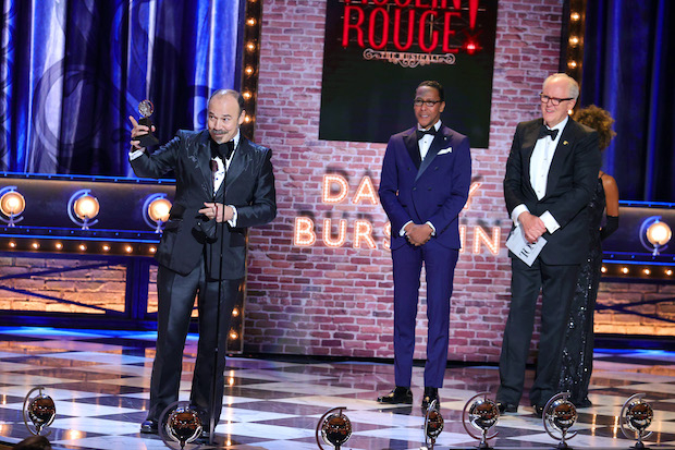 Danny Burstein accepts the Tony Award for Best Performance by an Actor in a Featured Role in a Musical for Moulin Rouge!, backed by presenters Ron Cephas Jones and John Lithgow.