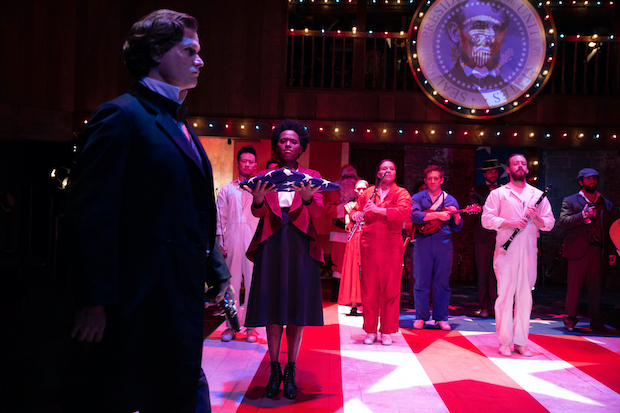 Steven Pasquale (foreground) plays John Wilkes Booth in the off-Broadway revival of Stephen Sondheim and John Weidman&#39;s Assassins, directed by John Doyle, at Classic Stage Company. 