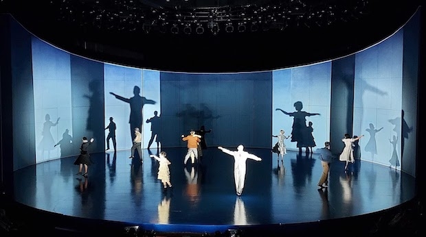 The cast of Flying Over Sunset dances on the stage in the opening sequence.