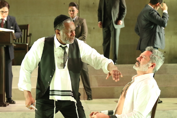 Shylock (John Douglas Thompson) prepares to cut his pound of flesh from Antonio (Alfredo Narciso) in the Theatre for a New Audience production of William Shakespeare&#39;s The Merchant of Venice, directed by Arin Arbus, at the Polonsky Shakespeare Center.