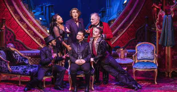 Simon Bailey (center) with the cast of Moulin Rouge! at the Piccadilly Theatre in London
