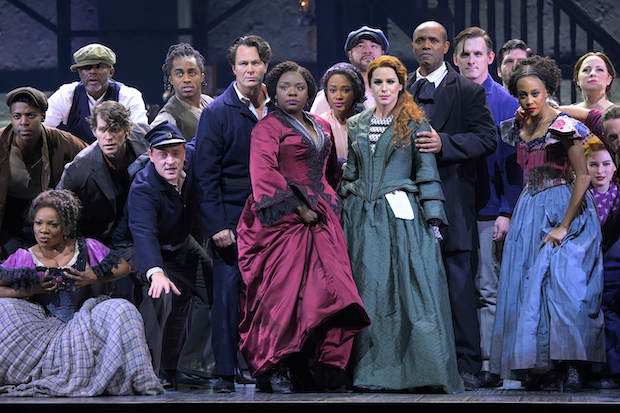 Joaquina Kalukango (center in red) leads the cast of Paradise Square, directed by Moisés Kaufman, at Broadway&#39;s Ethel Barrymore Theatre.