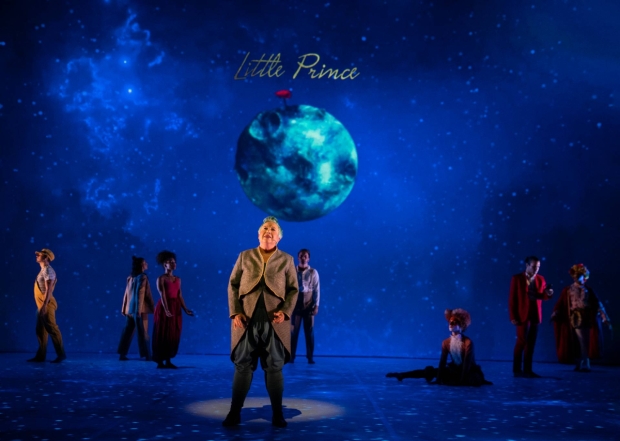 Chris Mouron (center) as the Aviator with cast members of The Little Prince.