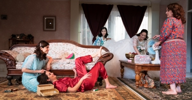 Marjan Neshat, Nazanin Nour, Nikki Massoud (behind couch), Roxanna Hope Radja (in white dress), and Artemis Pebdani appear in a scene from Wish You Were Here.