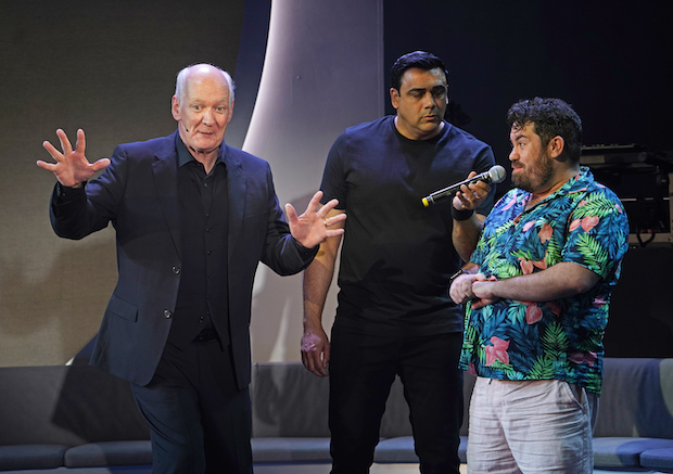 Colin Mochrie, Asad Mecci, and an audience volunteer perform in Hyprov: Improv Under Hypnosis, directed by Stan Zimmerman, at the Daryl Roth Theatre.