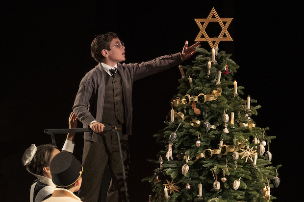 Young Jacob (Joshua Satine) places a Star of David on the Christmas tree in Leopoldstadt on Broadway. 