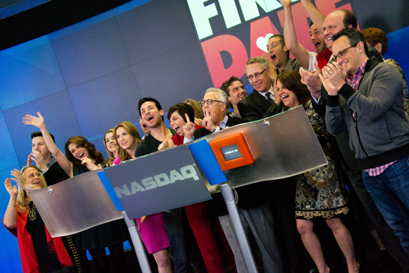 The cast and creative team of First Date ring the Nasdaq closing bell.