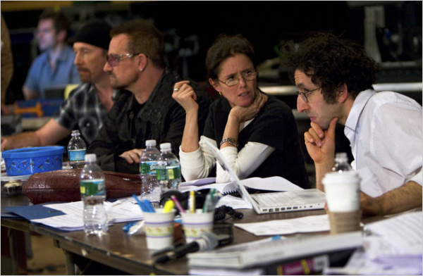 The Edge, Bono, Julie Taymor, and Glen Berger at work in the rehearsal room.